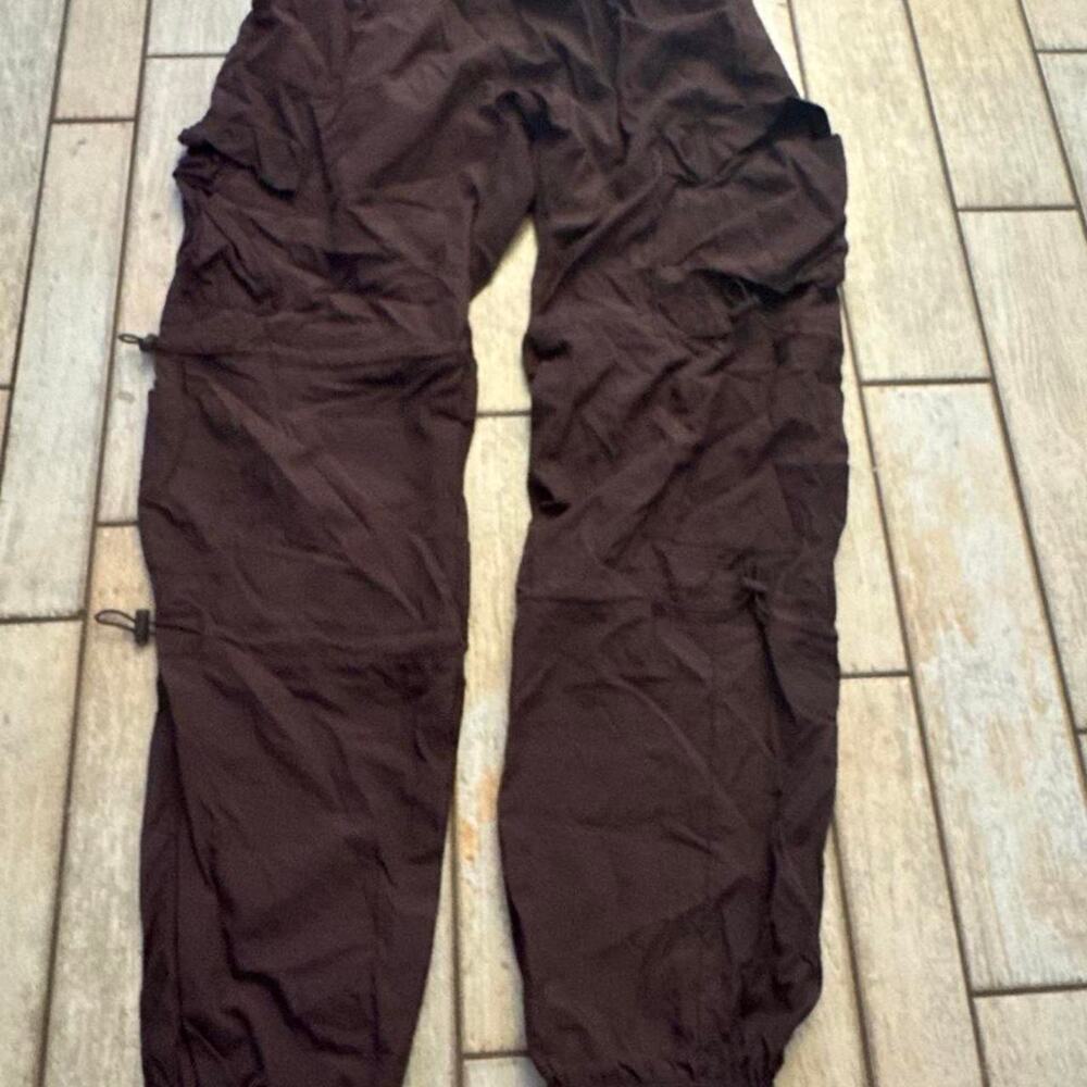 Brown cargo parachute pants with adjustable waist and ankles